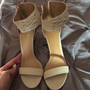 Cream colored high heels with lace up front